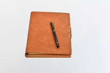 Leather notebook and pen.